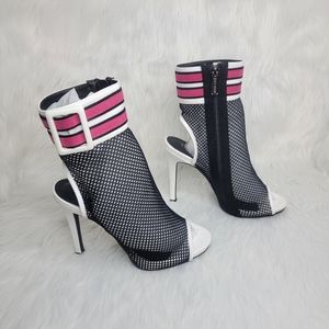Open toe black mesh stiletto heeled ankle boots.